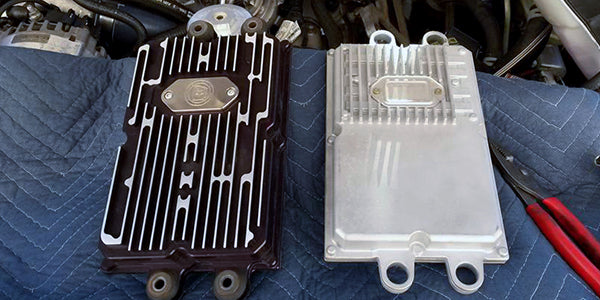 An Upgraded BulletProof FICM ready for installation, the OEM version is on the right side.